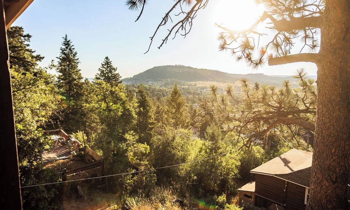 Palmer Lake House | Built in 1908 this historic cabin is full of original charm with a penthouse view. Step inside and you are immediately greeted by a full unobstructed view of Elephant Rock. Sleeping up to 9 people.