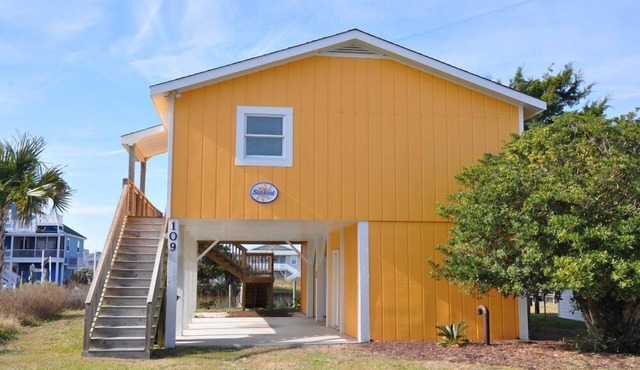 Coastal bungalow charm with dock, porch views, and easy beach access in a renovated retreat
